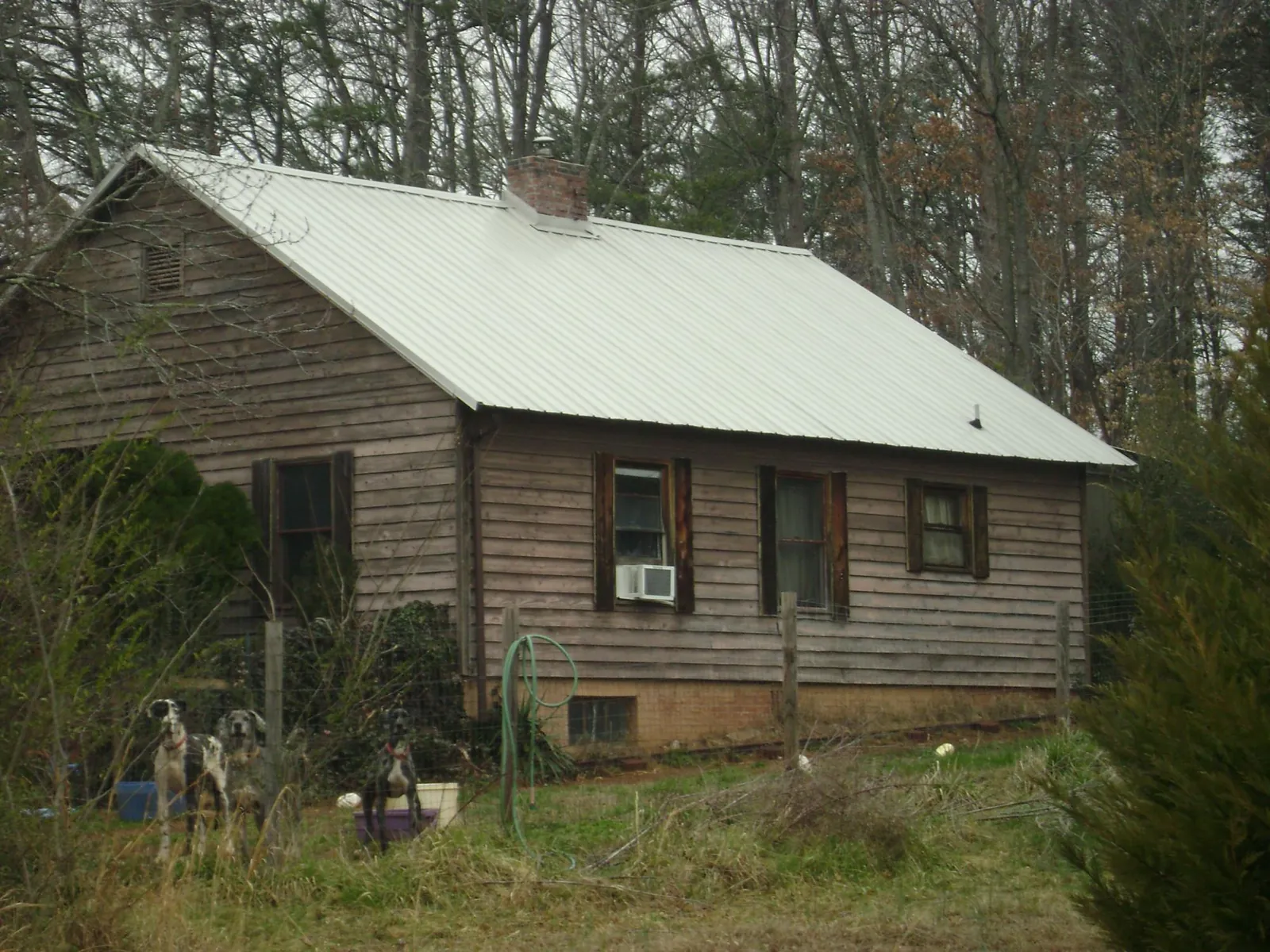 White metal roof on an old wood sided farmhouse, from a Metal Roof Installation job in High Ridge